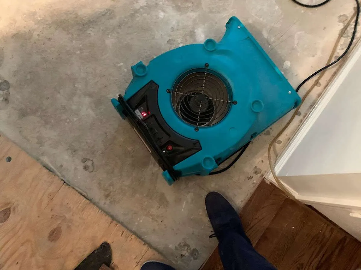 Air mover drying subfloor during Leak Detection & Repair in Oak Grove